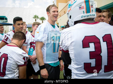 Davie, Florida, USA. 30th May, 2018. Miami Dolphins quarterback Ryan Tannehill (17) lets a player from Marjory Stoneman Douglas High School try on his helmet after organized team activities The Baptist Health Training Facility at Nova Southeastern University in Davie, Florida on May 30, 2018. Credit: Allen Eyestone/The Palm Beach Post/ZUMA Wire/Alamy Live News Stock Photo