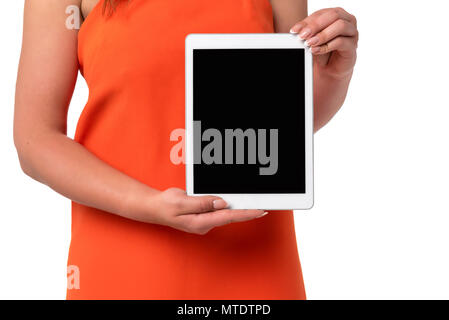 Technology advertising concept image - woman in orange dress with perfect fingernails holding digital tablet with blank screen. Stock Photo