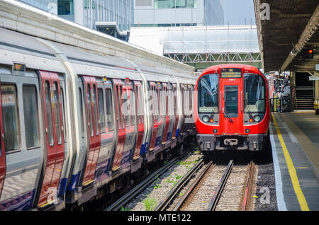 A train departs from the platform at Hammersmith London Underground Station. Stock Photo