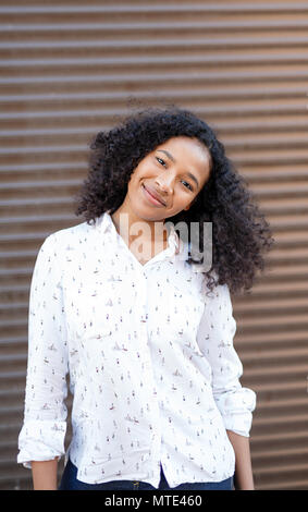 Smiling woman with afro hair looking at camera Stock Photo