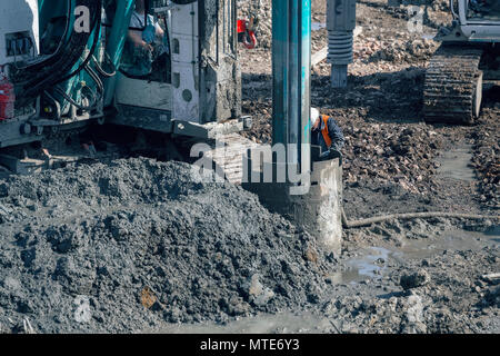 Drilling rig making deep foundation at construction site,  rotary drilling machine heavy equipment. Extreme construction machinery. Stock Photo