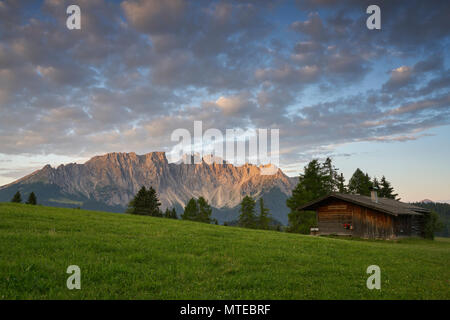 Latemar mountain range with alpine huts, cloudy skies, in the morning, Karerpass, South Tyrol, Italy Stock Photo