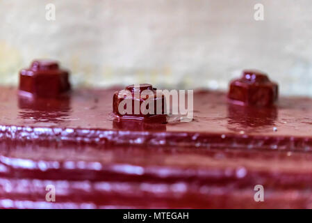 Industrial metal surface with three nuts close Stock Photo