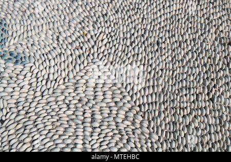 Bridge of round sea stones. Abstract structured background. Stock Photo