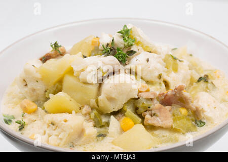 A  bowl of chowder made from pollack, Pollachius pollachius, diced smoked bacon, potatoes, celery, sweetcorn, onion, single cream, fish stock and flav Stock Photo