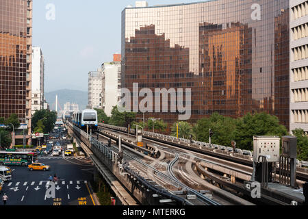 An Innovia APM 256 train traveling on elevated rails approaches the Zhongshan Junior High School station, in Taipei, Taiwan Stock Photo