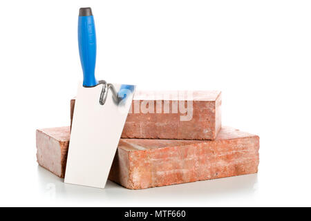 Trowel with bricks on white background - home construction or renovation concept Stock Photo