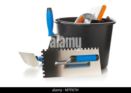 Masonry tools - trowels, notched trowel and mortar bucket - on white background Stock Photo