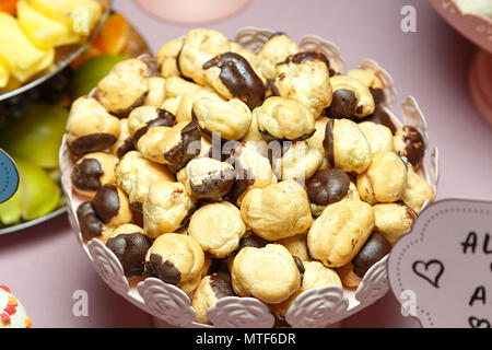 many mini chocolate eclairs with lined slide in plate, festive Candy Bar Stock Photo