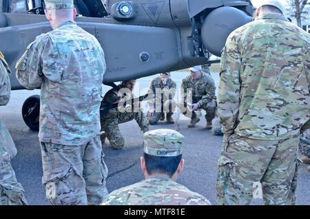 ADAZI, Latvia – Soldiers from Company C, 1st Battalion, 501st Aviation Regiment, 1st Armored Division out of Fort Bliss, Texas attached to Task Force Falcon, land their AH-64D Apache attack helicopter at the parade field on Ādaži military base during Operation Summer Shield as a part of Operation Atlantic Resolve, April 24, 2017. As part of Operation Summer Shield the pilots and crew briefed the Joint Terminal Attack Controller (JTAC) crews stationed at Ādaži Military base, which consisted of U.S. Army and Air Force as well as Latvian armed forces, of the capabilities the Apache attack helicop Stock Photo