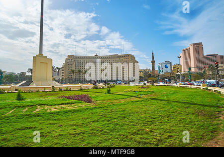 CAIRO, EGYPT - DECEMBER 24, 2017: Panoramic view of Midan Al Tahrir square with green lawn in the middle and administrative buildings on background, o Stock Photo