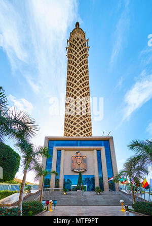 CAIRO, EGYPT - DECEMBER 24, 2017: The entrance to Cairo Tower, decorated with the State Emblem of Egypt - the eagle, and surrounded by garden, on Dece Stock Photo