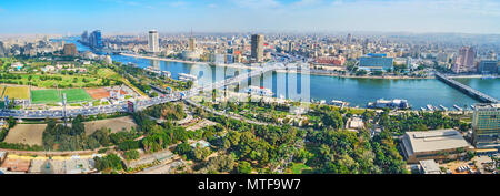 CAIRO, EGYPT - DECEMBER 24, 2017: Aerial view of Gezira Island with wide green areas - gardens or park and Downtown district with dense housing and br Stock Photo