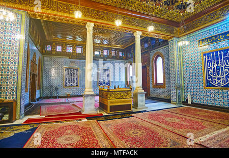 CAIRO, EGYPT - DECEMBER 24, 2017: The rich interior of the mosque of Manial Palace with masterpiece tilework, complex carved ceiling, Arabic inscripti Stock Photo