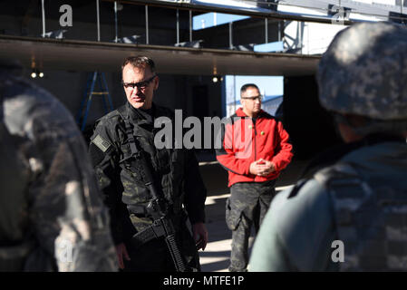 Paul Gregory, Adam County Sheriff Department academy director and training unit commander, briefs the 460th Security Forces Squadron Emergency Services Team Apr. 22, 2017, at the Flatrock Regional Training Center in Commerce City, Colo. Gregory, and team members from the Adams County Sheriff Department Special Weapons and Tactics team, spent three days training the 460th SFS EST in tactical movements for several possible scenarios. Stock Photo