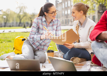 Two pleasant students studying outside together Stock Photo