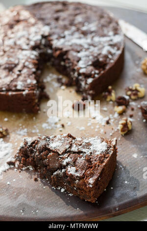 Chocolate Brownie with powdered sugar, chocolate chips, and walnuts. On a baking sheet. Stock Photo