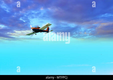 Airplane flying between stormy clouds Stock Photo