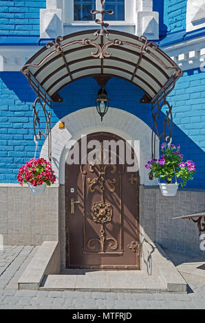 Metal forged front door leading to the basement of an ancient castle Stock Photo