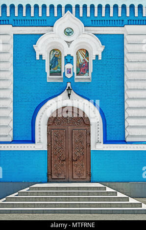 Closed metal forged front door leading inside the Orthodox Church Stock Photo