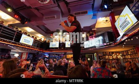 Waiters performing songs from the musicals at Ellens Stardust Diner restaurant, while diners look on, Broadway, New York city USA Stock Photo