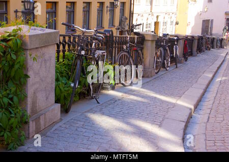 A row of bicycles parked along Södra Benickebrinken, Gamla Stan, Stockholm, Sweden Stock Photo