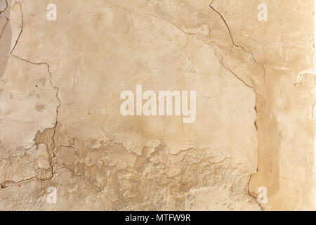 Weathered plastered and painted wall background, partially faded Stock Photo