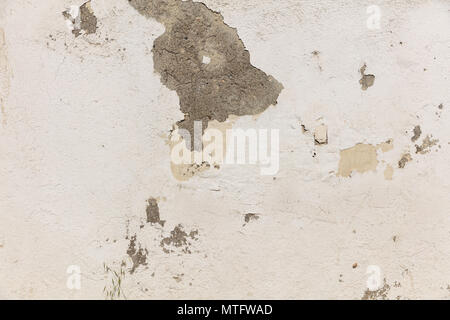 Weathered plastered and painted wall background, partially faded Stock Photo