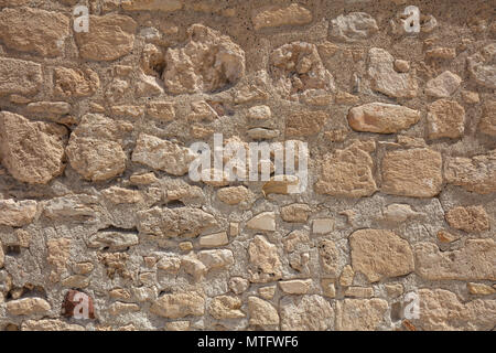 Traditional weathered sand stone wall background in Cyprus Stock Photo