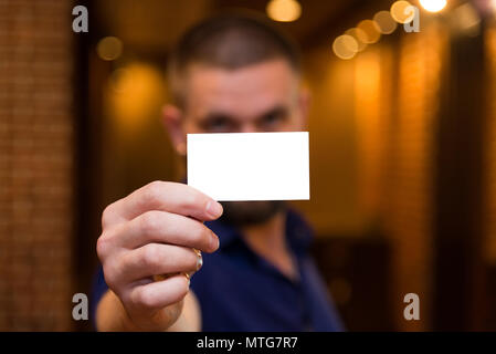 White card in the hands of the men in the background Stock Photo