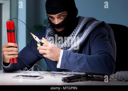 Terrorist bomber preparing dynamite bomb Stock Photo