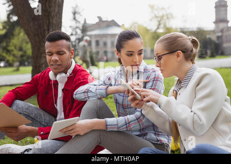 Three diligent students preparing for international test Stock Photo