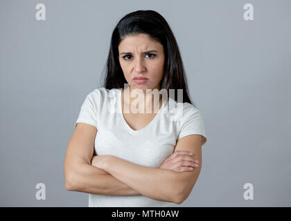 Close up portrait of an attractive young latin woman with an angry face. looking furious and moody with an intense look showing anger and rage. Human  Stock Photo