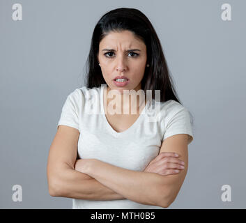Close up portrait of an attractive young latin woman with an angry face. looking furious and moody with an intense look showing anger and rage. Human  Stock Photo