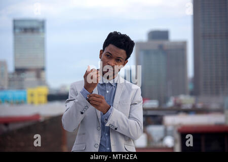 business man buttoning up shirt cuff Stock Photo