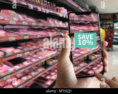 Family in the supermarket use Application of Augmented Reality Supermarket for Discounted or on Sale Stock Photo