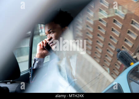 Business man seen through car window Stock Photo