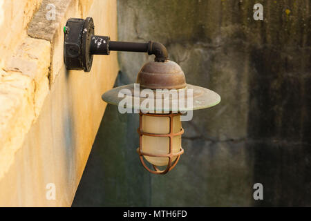 an old outdoor light fixture in a stairwell Stock Photo