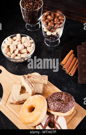 Donuts, peanuts in chocolate and coffee beans Stock Photo