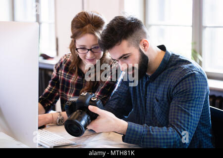 Two young designers working in modern office Stock Photo