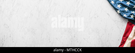 Close-up american flag on white marble background. Stock Photo