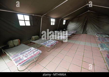Tent shelter with temporary beds ready for natural disaster refuges ...