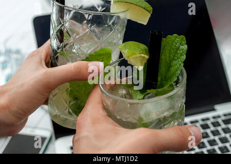two glasses of mojito on laptop background Stock Photo