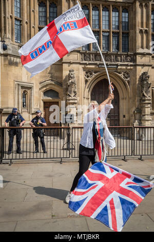 Nationalist supporters of Tommy Robinson protest outside Westminster's Parliament buildings against his recent imprisonment for contempt of court. Stock Photo