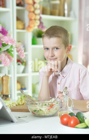 Cute little boy making dinner Stock Photo