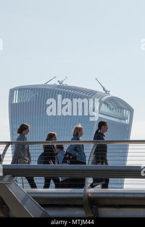 a group of  young ladies or women walking across blackfriars bridge on their way to work during the morning commute in central london city skyline. Stock Photo