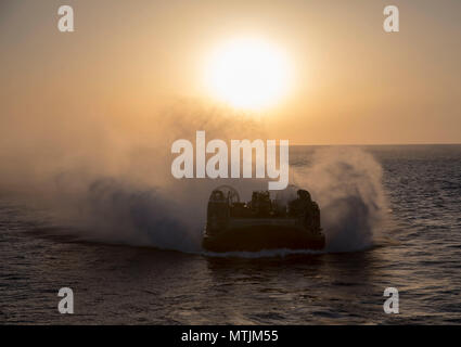 U.S. Navy Landing Craft, Air Cushion 84, attached to Assault Craft Unit 4, enters the well deck of the San Antonio-class amphibious transport dock ship USS New York (LPD 21) May 24, 2018, in the Mediterranean Sea. New York, homeported in Mayport, Florida, is conducting naval operations in the U.S. 6th Fleet area of operations in support of U.S. national security interest in Europe and Africa. (U.S. Navy photo by Mass Communication Specialist 2nd Class Lyle Wilkie) Stock Photo