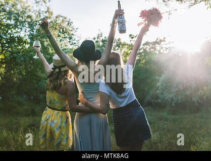 Group of girls friends making picnic outdoor. They have fun Stock Photo