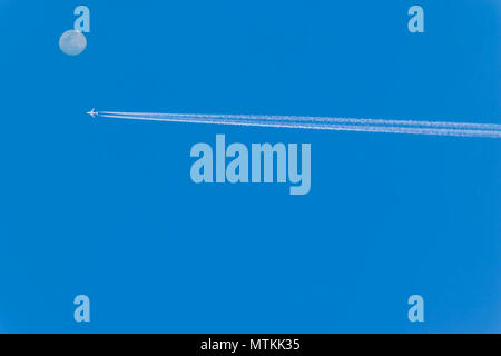 Abstract soft blurred and soft focus the airplane with white smoke on blue sky background. Stock Photo