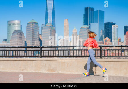 Healthy lifestyle. Woman is running in New York. Fitness sports runner is jogging in  the city Stock Photo